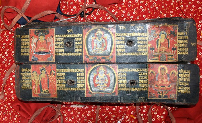 Folios 127v-128r with original 13th-century painted panels.